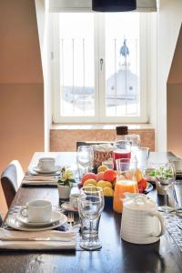 a table with food and drinks on top of it at Lisbon Five Stars Apartments São Julião 72 in Lisbon
