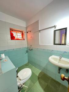 a bathroom with a toilet and a sink at SkyView Villa in Candolim