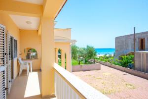 a balcony of a house with a view of the ocean at Apartments Facini in Košljun
