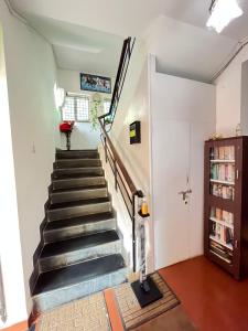 a staircase in a house with a cat standing next to it at SkyView Villa in Candolim
