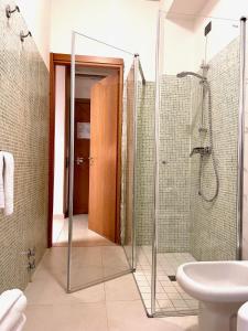 a bathroom with a shower and a toilet and a sink at Hotel Leonardo in Brescia