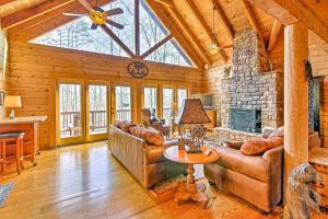 a living room with a couch and a fireplace at Lake Hartwell Lodge with Dock, Theater and Hot Tub! in South Union