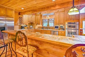 a large kitchen with a large wooden counter top at Lake Hartwell Lodge with Dock, Theater and Hot Tub! in South Union