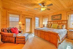 a bedroom with a bed and a ceiling fan and a chair at Lake Hartwell Lodge with Dock, Theater and Hot Tub! in South Union