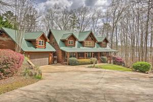 a log home with a green roof and a driveway at Lake Hartwell Lodge with Dock, Theater and Hot Tub! in South Union