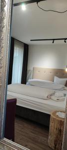 a bedroom with a large bed in a mirror at Pension Fellis in Vols am Schlern