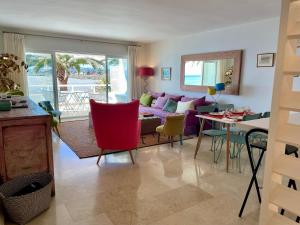 a living room with a couch and a table at Sotogrande Paseo del Rio in Sotogrande