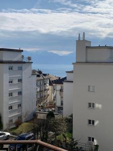 a view of two white buildings in a city at City appartement in Lausanne