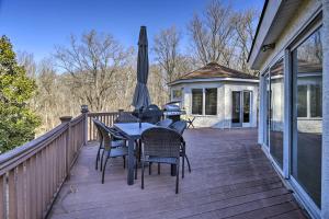 a deck with a table and chairs and an umbrella at Newark Rental Near University of Delaware! in Newark