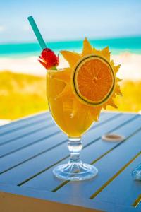 a drink in a glass with a slice of orange at Baía Branca Beach Resort in Tamandaré
