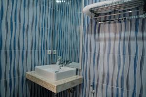 Ванная комната в Christika Homestay +34 фотографии