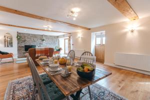 a living room with a table with fruit on it at The Grain Loft in Clun