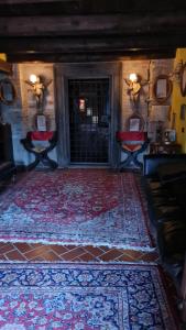 a room with a rug and two chairs and a door at Convento Di San Martino in Crocicchio in Urbino