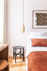 - une chambre avec un lit et une table dans l'établissement Hôtel Le Mosaïque, à Narbonne