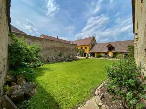 a yard with a stone wall and a house at Burg St. Veit, Wohnen mit Charme in Sankt Veit an der Glan