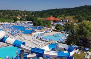 a large water park with several pools and umbrellas at Vila Siki in Rakari