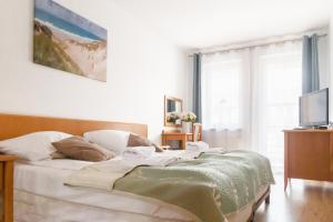 Posteľ alebo postele v izbe v ubytovaní AL-DOM apartamenty Blue Olymp 203