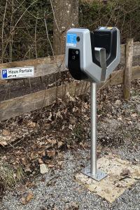 a parking meter in front of a fence at Haus Partale in Oberstdorf