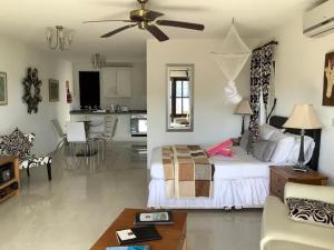 a large living room with a bed and a kitchen at IJEOMA HOUSE in Bequia