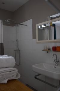 a bathroom with a sink and a mirror at Hôtel Absolu in Castelsarrasin