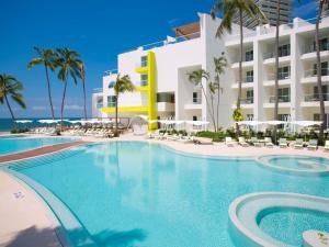 a swimming pool in front of a hotel at Krystal Grand Puerto Vallarta - All Inclusive in Puerto Vallarta