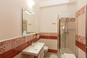 a bathroom with a toilet sink and a shower at B&B Mazzini in Alba Adriatica +6 photos