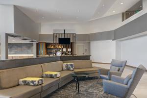 a lobby with a couch and two chairs and a table at SpringHill Suites by Marriott Palm Desert in Palm Desert