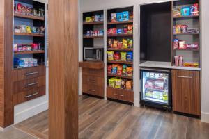 a walk in pantry with a refrigerator and lots of food at Courtyard by Marriott Memphis East Galleria in Memphis