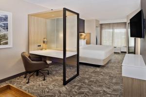 a hotel room with a bed and a desk at SpringHill Suites Birmingham Colonnade in Birmingham