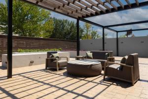 eine Terrasse mit mehreren Stühlen und einem Tisch in der Unterkunft Courtyard by Marriott Memphis East Galleria in Memphis