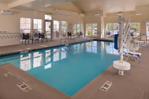 a large pool with blue water in a building at Residence Inn by Marriott Albuquerque Airport in Albuquerque
