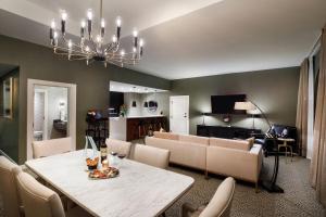 a dining room and living room with a table and chairs at Hotel Vin, Autograph Collection in Grapevine