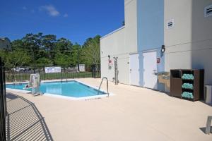 a swimming pool next to a building at TownePlace Suites by Marriott Charleston-North Charleston in Charleston