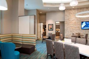 a lobby with a waiting room with tables and chairs at Residence Inn by Marriott Ann Arbor Downtown in Ann Arbor