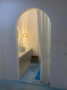a white bathroom with a sink and a mirror at Guru Canggu in Canggu