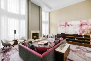 a living room with two couches and a fireplace at Courtyard by Marriott Dallas Lewisville in Lewisville