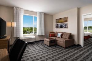 a living room with a couch and a bed at TownePlace Suites by Marriott Memphis Olive Branch in Olive Branch