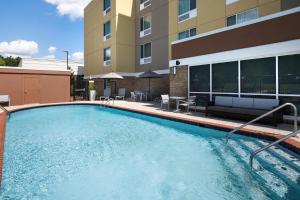a large swimming pool in front of a building at TownePlace Suites by Marriott Memphis Olive Branch in Olive Branch