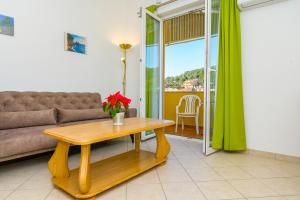 a living room with a couch and a table at Apartment Chiara Martinscica in Martinšćica