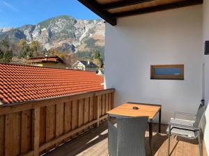 a balcony with a table and a view of a mountain at Schusterbrand Appartements in Absam