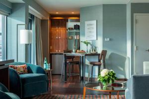 a living room with a couch and a table at Courtyard Burlington Harbor in Burlington