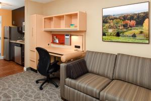 an office with a couch and a desk in a room at TownePlace Suites by Marriott Detroit Commerce in Walled Lake