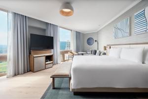 a hotel room with a large bed and a flat screen tv at JW Marriott Hotel Mexico City Polanco in Mexico City