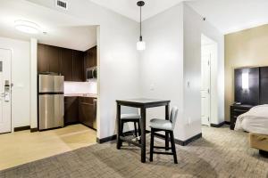 a kitchen with a table and two chairs in a room at Residence Inn by Marriott Corpus Christi Downtown in Corpus Christi