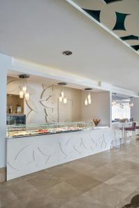 a kitchen with a white counter with a counter top at Prive Hotel Bodrum - Adult Only in Bodrum City