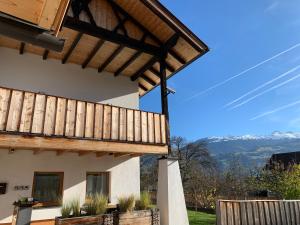 a view of a house with a wooden pergola at Schusterbrand Appartements in Absam