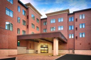 a large red brick building with a balcony at Residence Inn by Marriott Flagstaff in Flagstaff