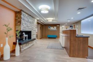 a lobby with a stone fireplace in a hospital at Fairfield Inn by Marriott Burlington Williston in Burlington