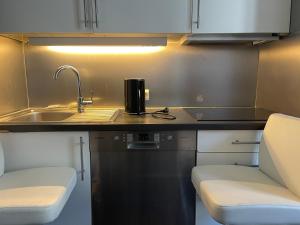 a small kitchen with a sink and a counter at Oslo center 4 in Oslo