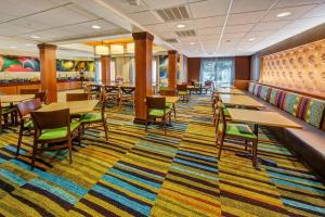 a restaurant with tables and chairs and a colorful carpet at Fairfield by Marriott Russellville in Russellville